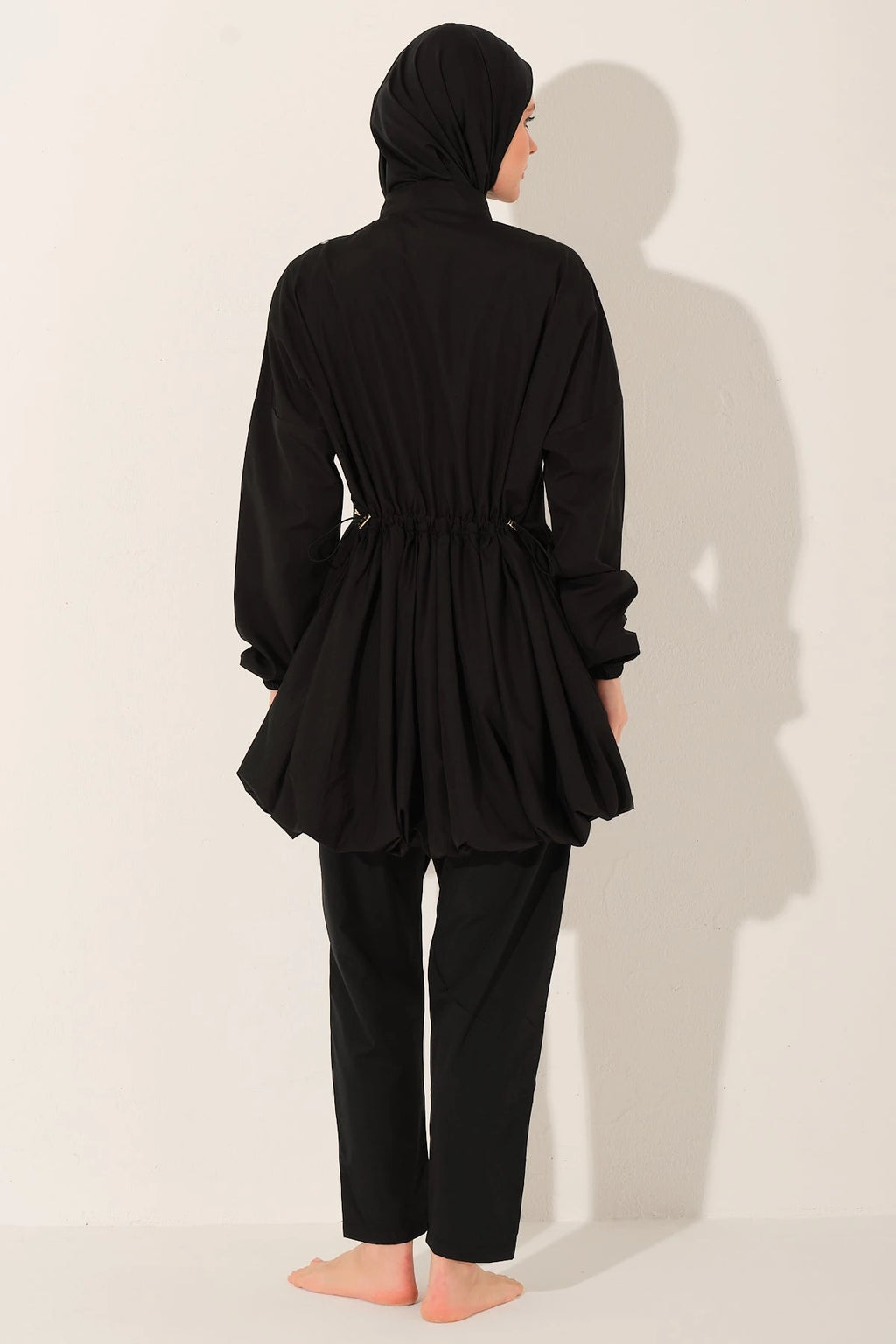 Black burkini swimsuit with adjustable waist detail, back view.