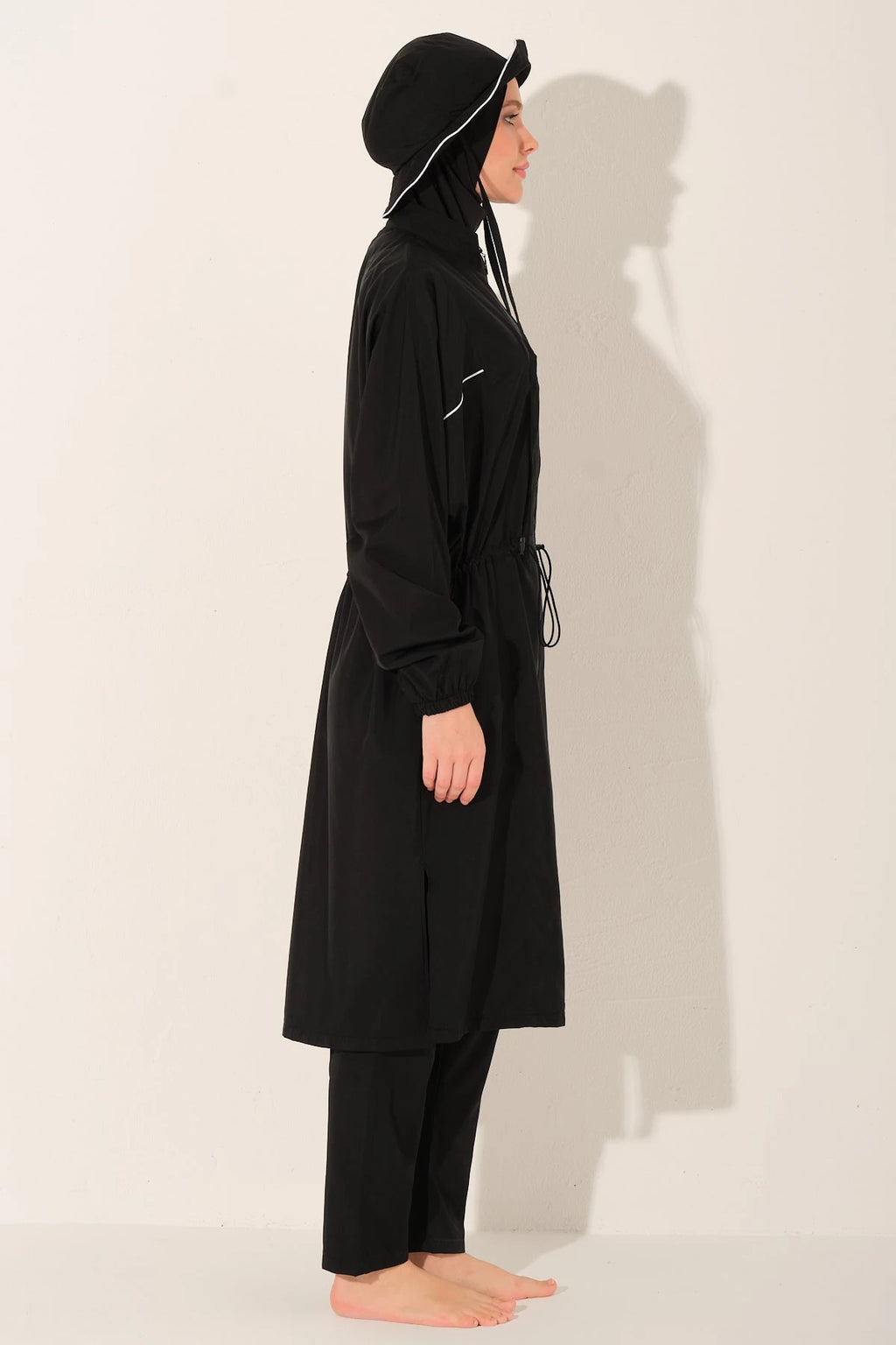 Black burkini set with long top and bucket hat side profile.