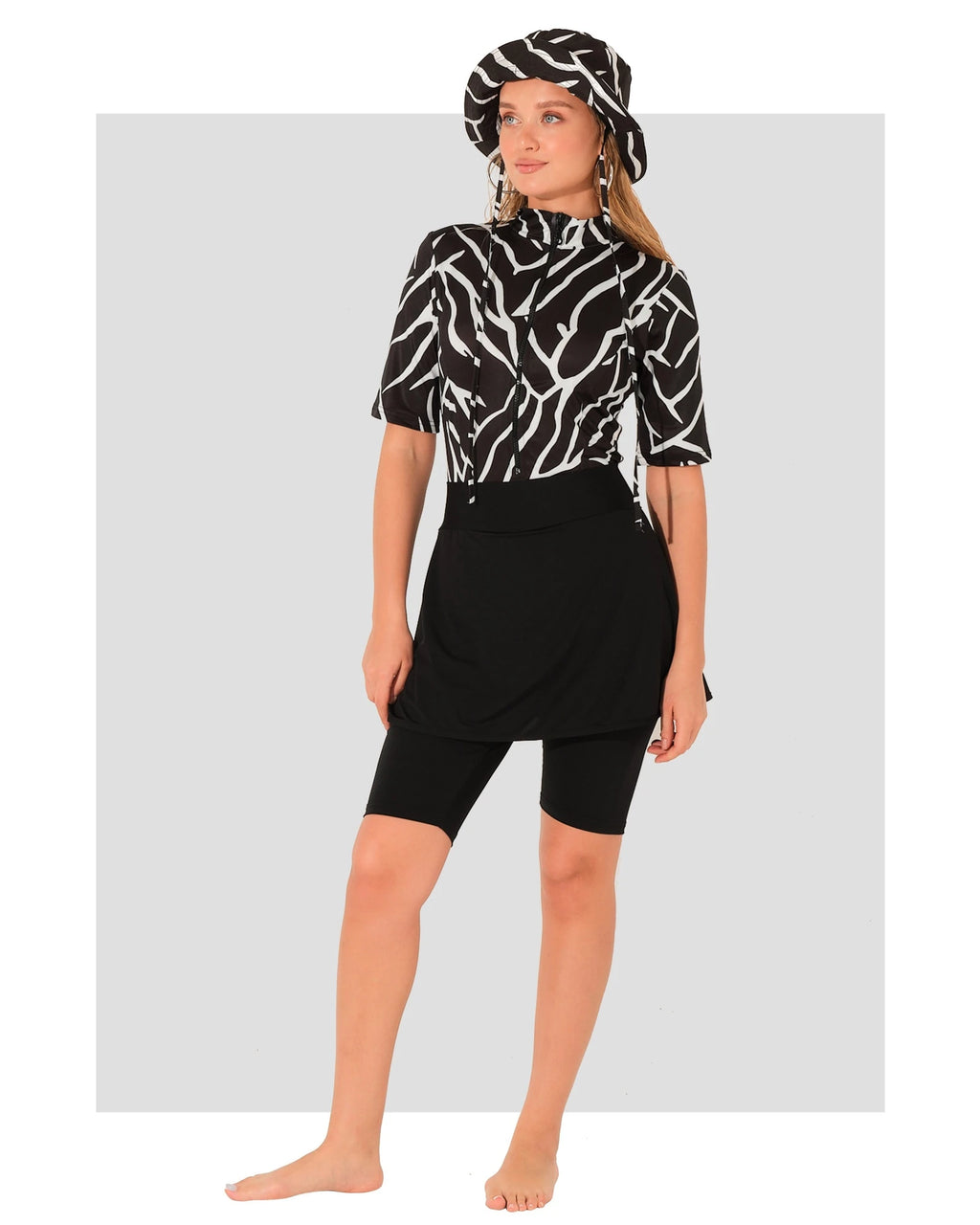 Woman in monochrome sport burkini set with bucket hat, front view.