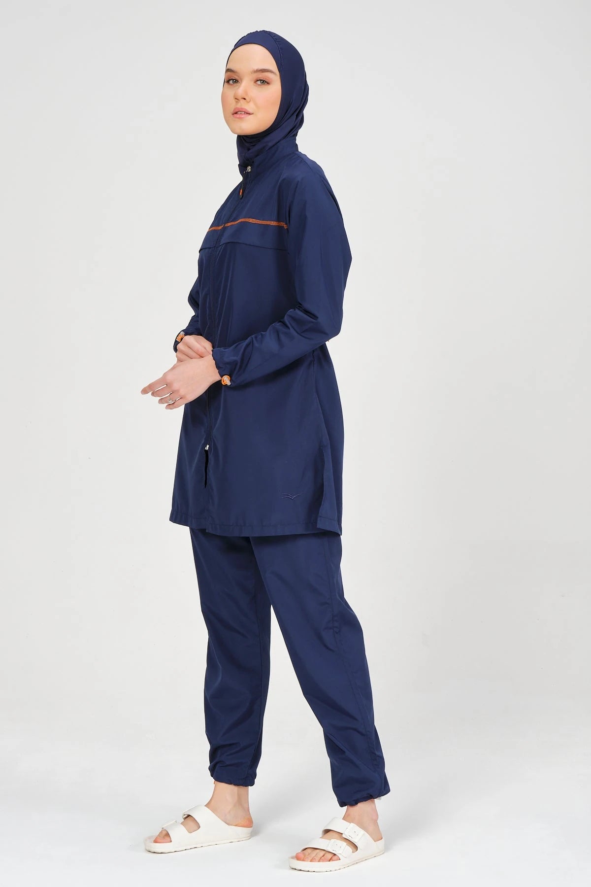 Navy blue burkini set with jogger-style pants, side view.