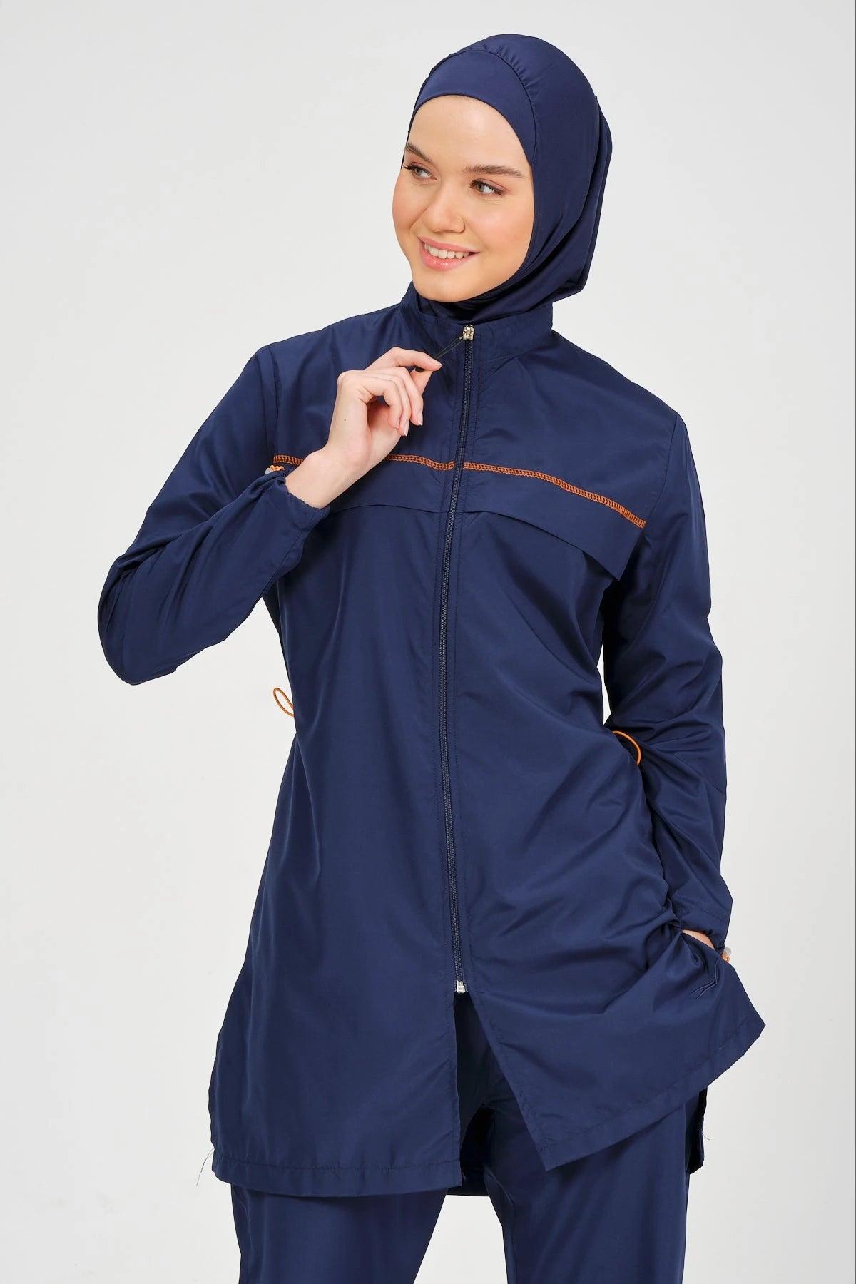 Navy blue burkini set close-up on zipper and contrast piping detail.