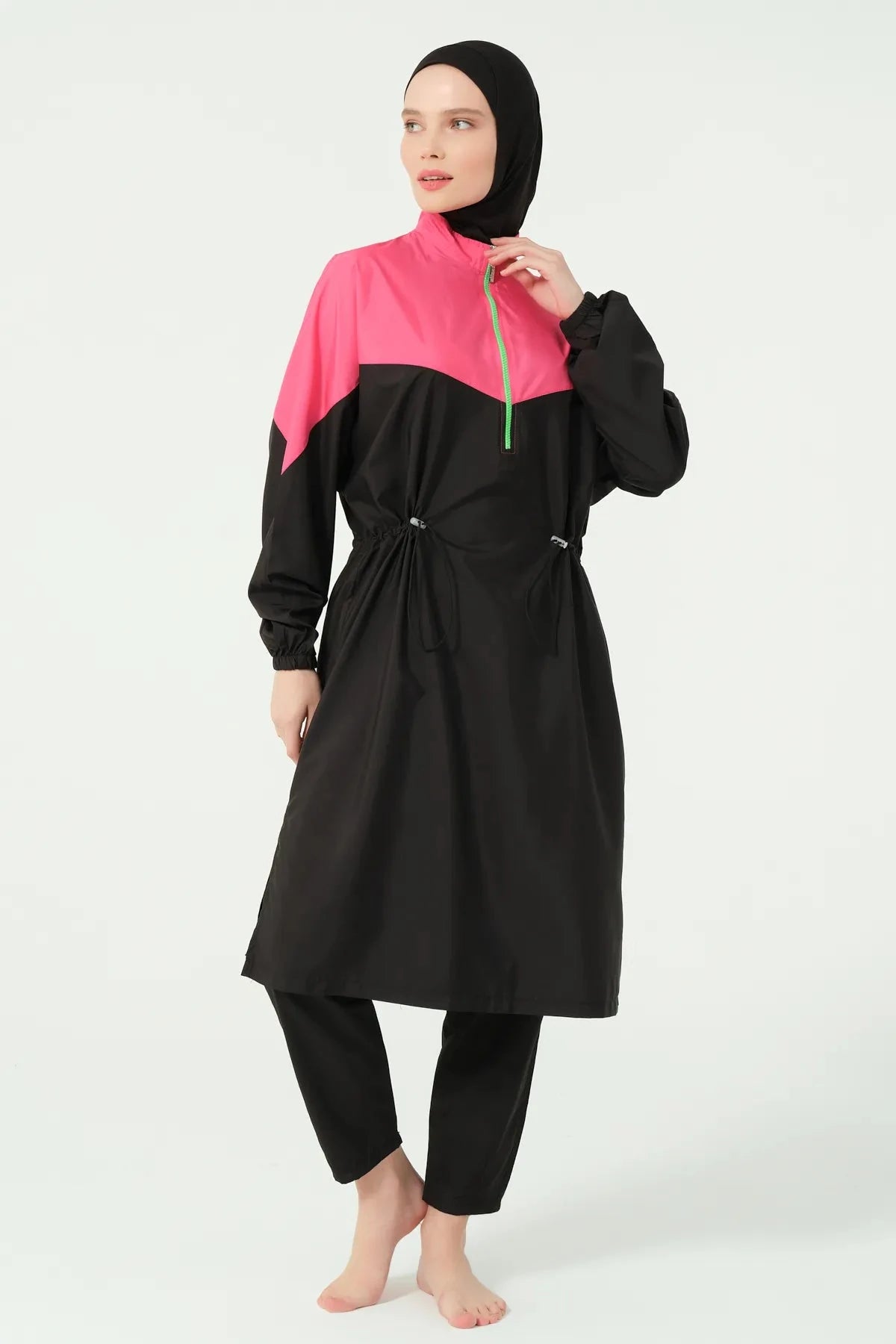 Close-up of the sporty burkini's fuchsia panel and neon green zipper detail.