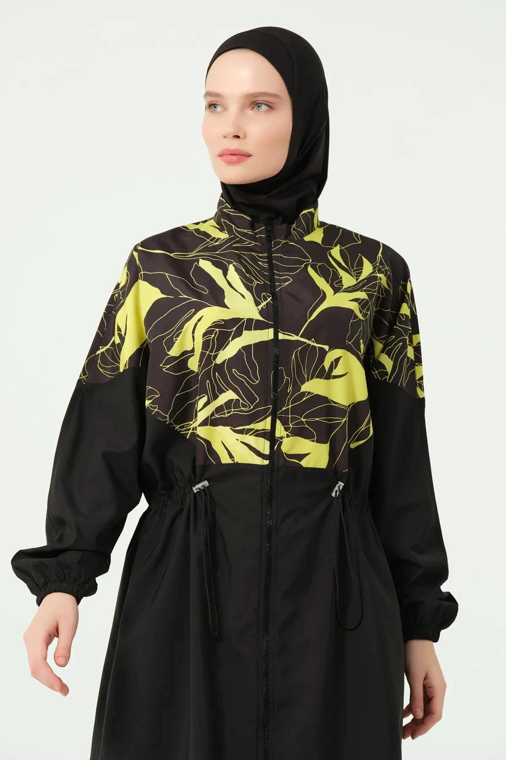 Close-up of the black and yellow tropical print burkini top front.