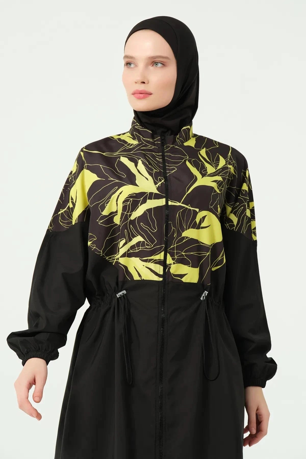 Close-up of the black and yellow tropical print burkini top front.