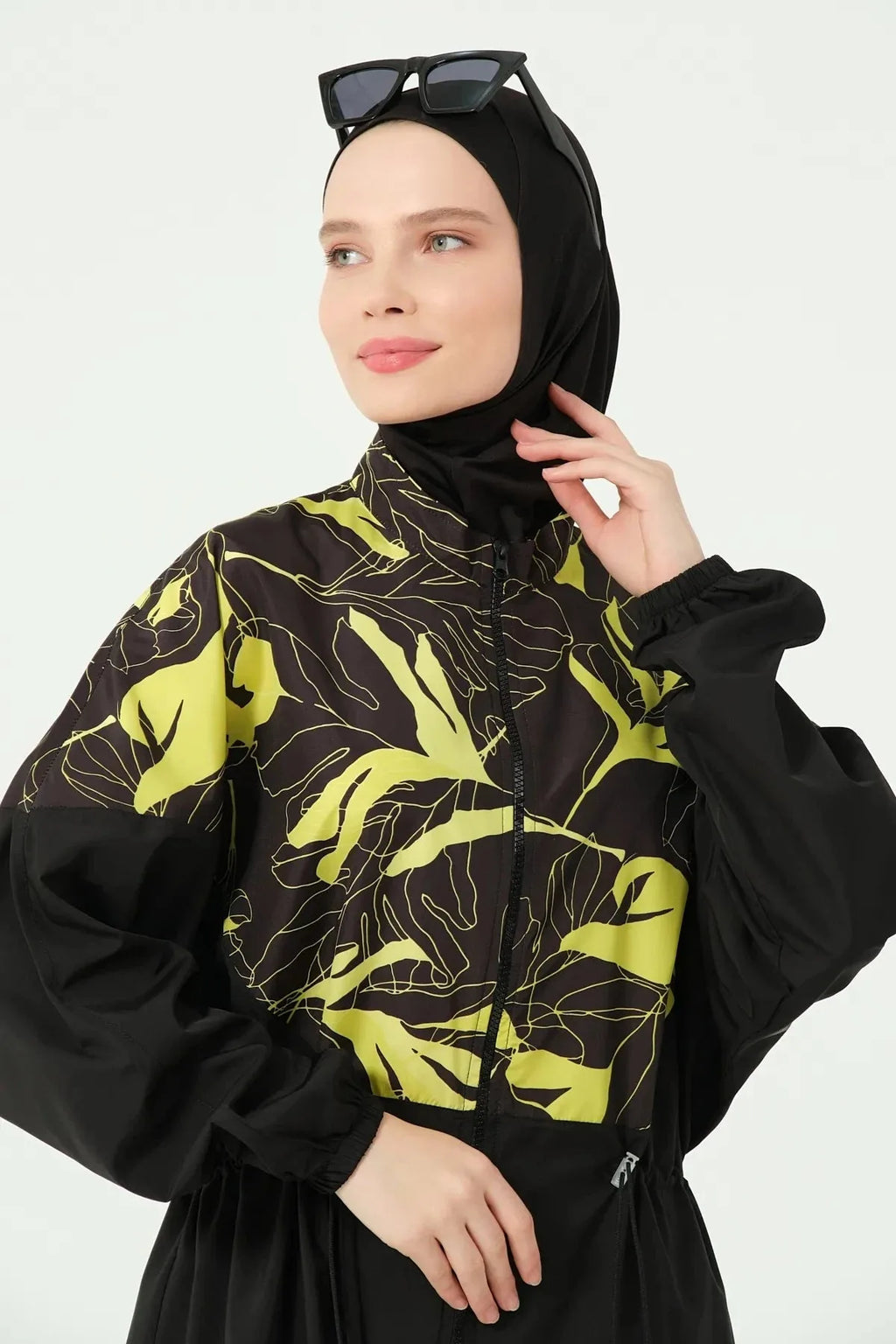 Close-up of the yellow and black tropical print on the burkini sleeve.