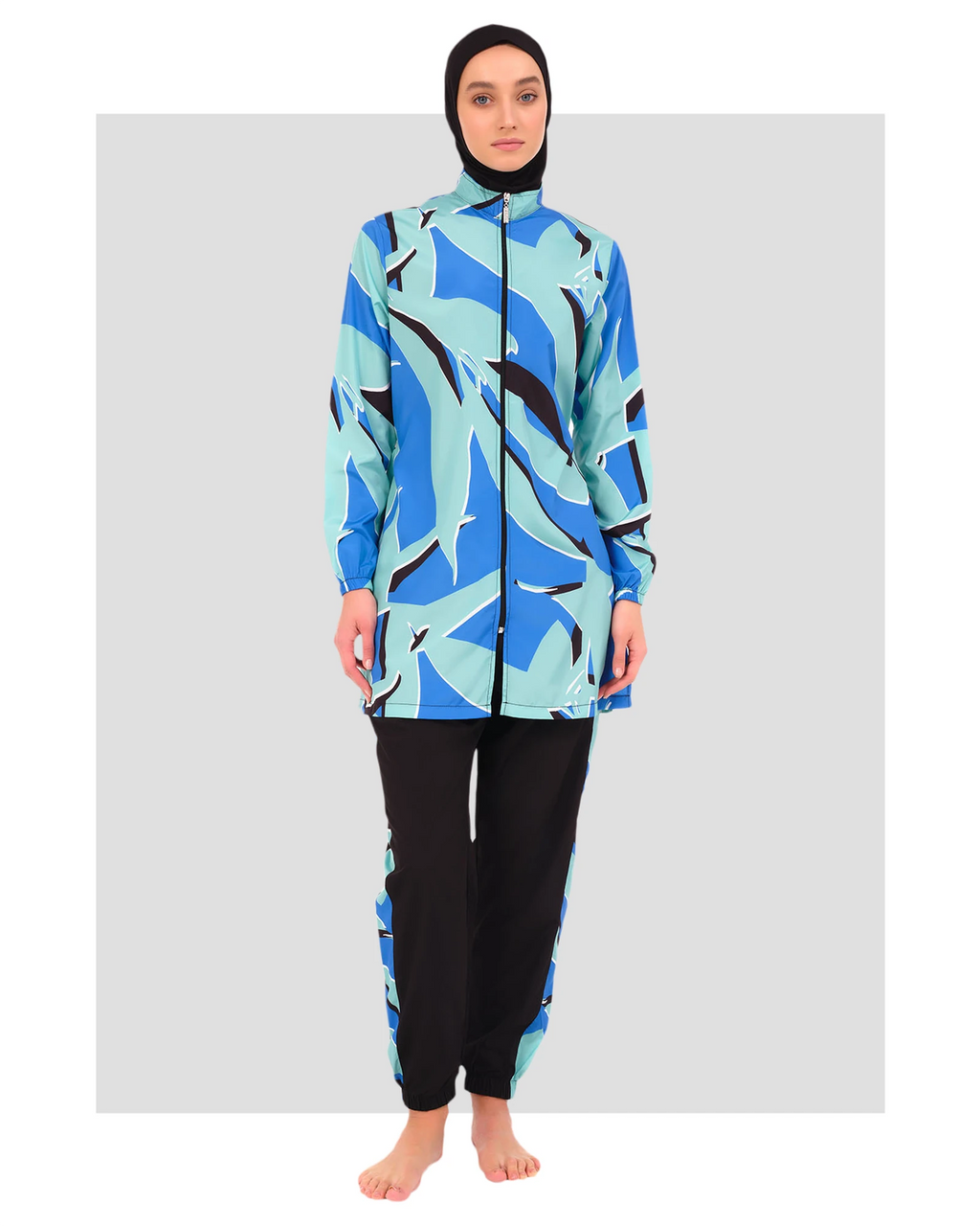 Woman in abstract print burkini set, front view, black hijab.