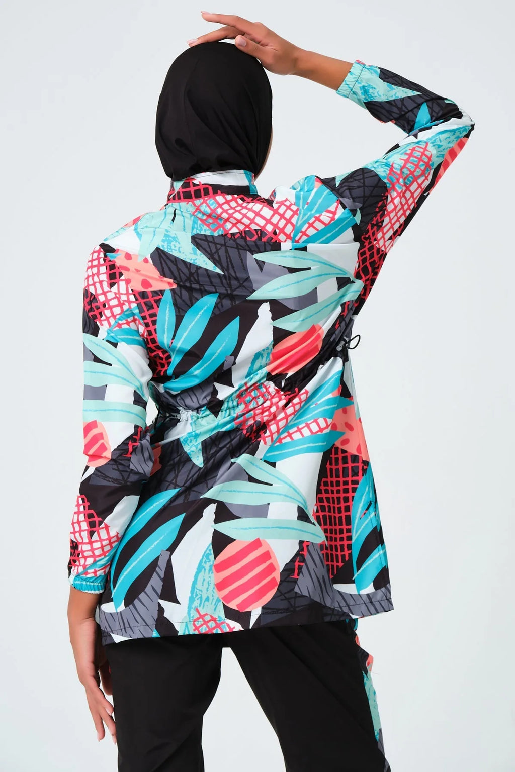 Back view of tropical print burkini top showing adjustable waist drawstring.