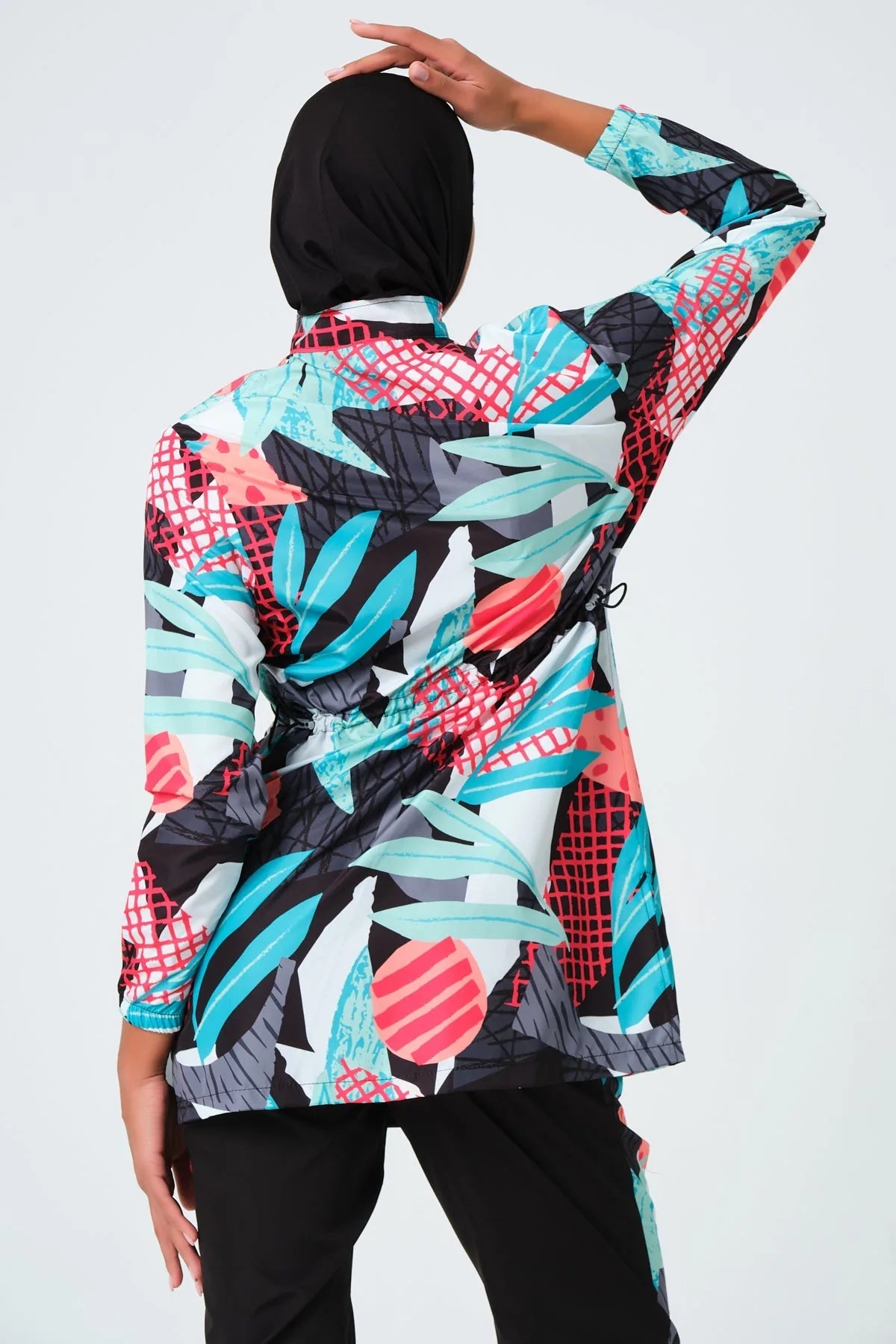 Back view of tropical print burkini top showing adjustable waist drawstring.