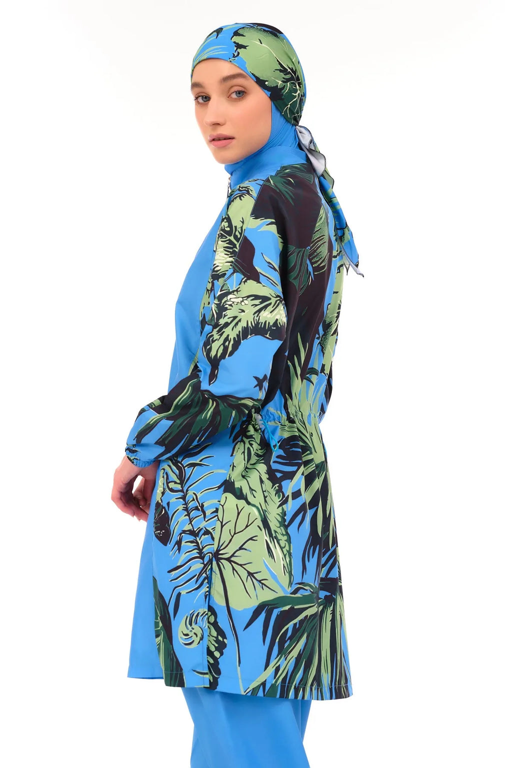 Blue burkini with tropical print sleeves and side panels, close-up.