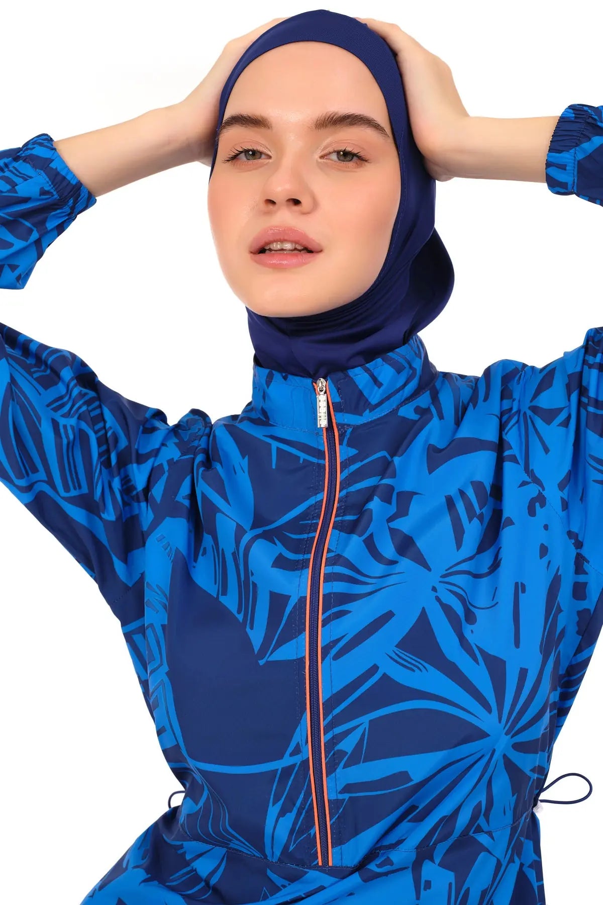 Close-up of blue patterned burkini top with zipper and matching hijab.