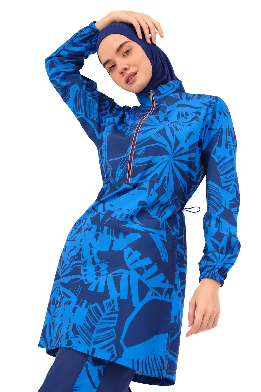 Close-up of blue patterned burkini top with model posing.
