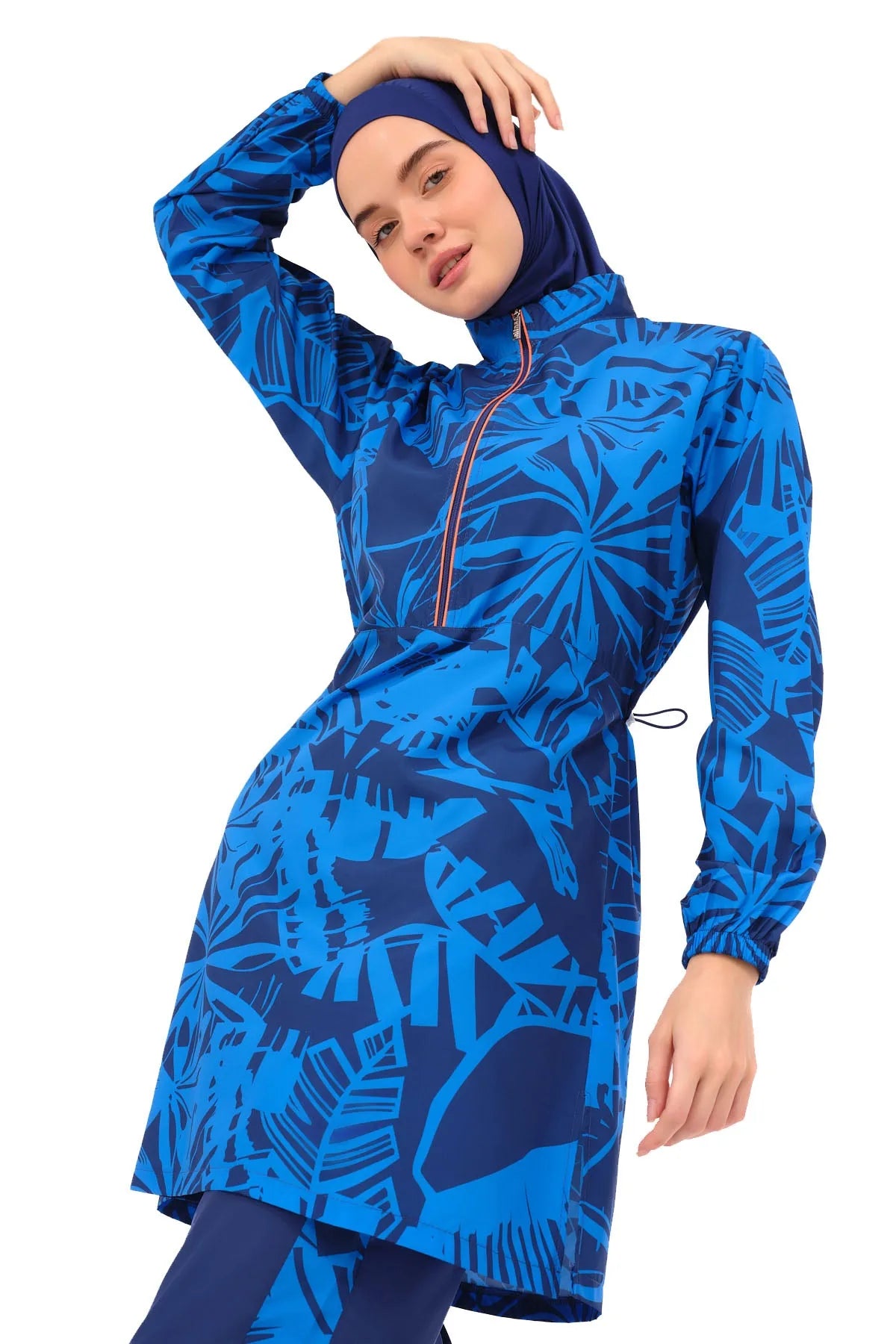 Close-up of blue patterned burkini top with model posing.