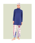 Model in blue and patterned burkini set, front view, standing on white background.