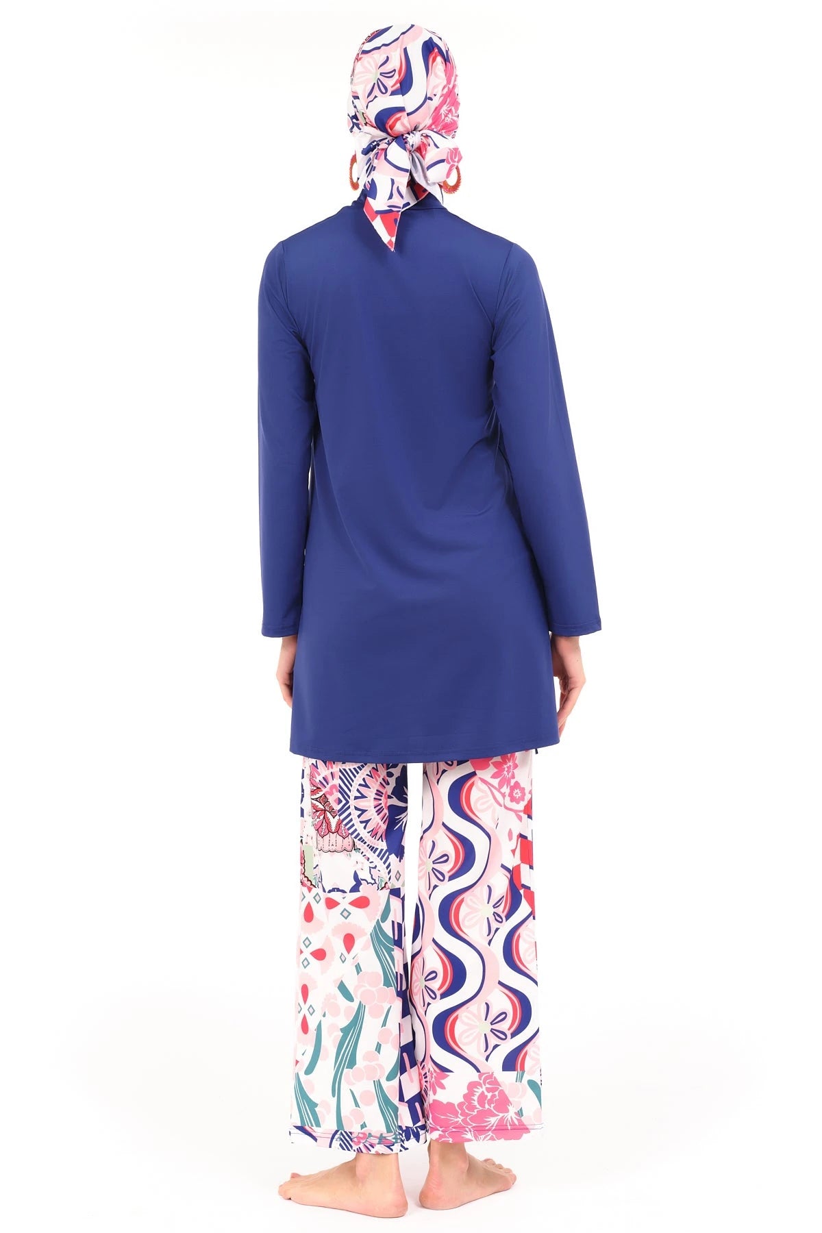 Model in blue and patterned burkini set, back view, standing on white background.
