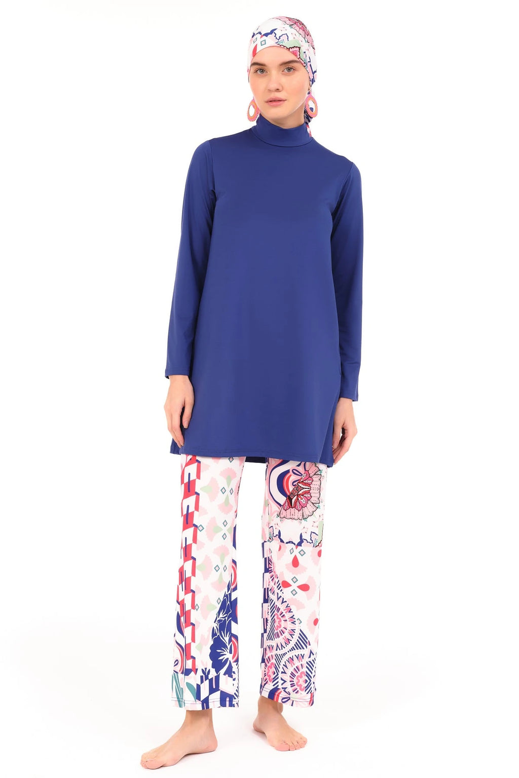 Model in blue and patterned burkini set, full front view, standing on white background.