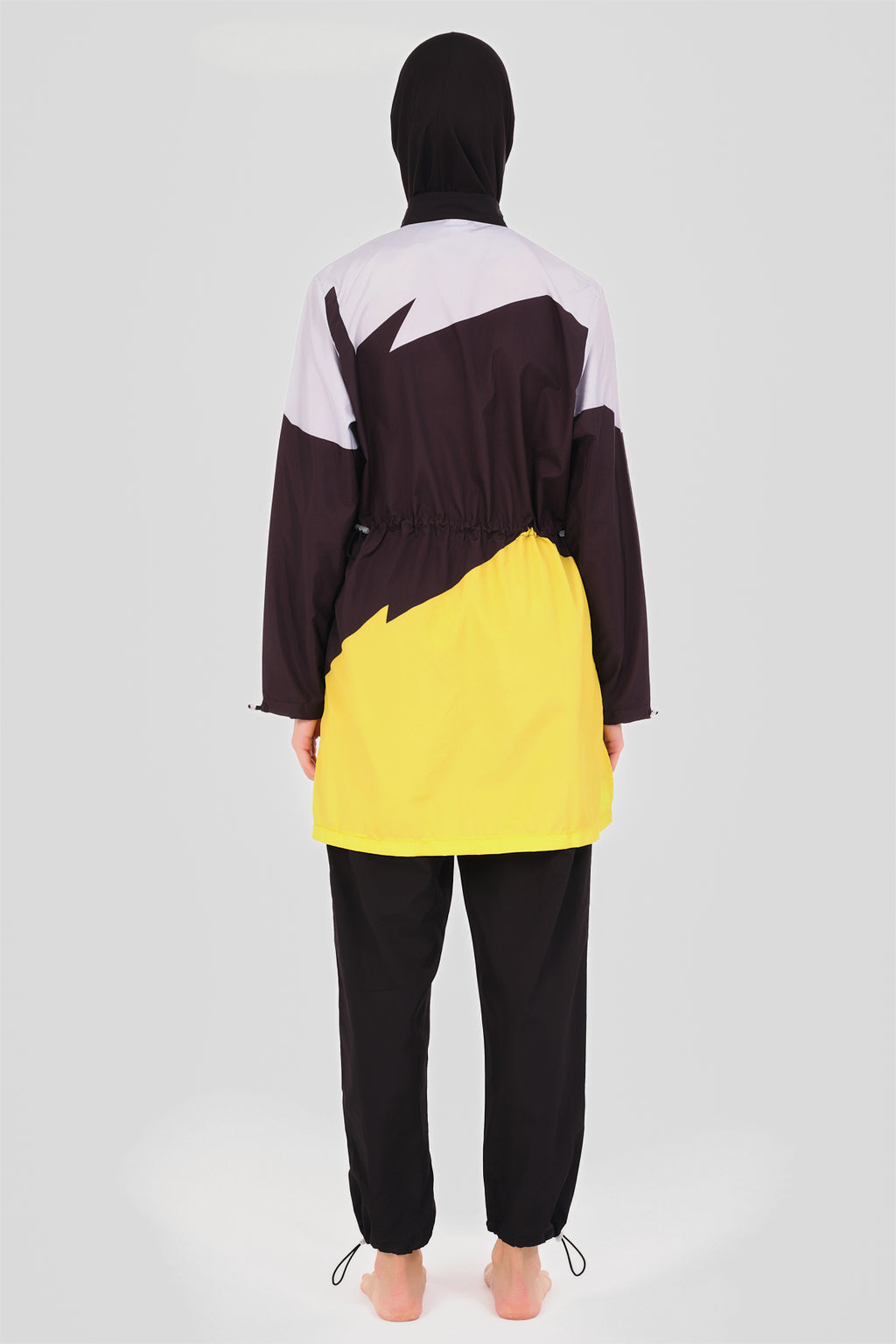 Back view of sporty color-block burkini showing adjustable waist drawstring.