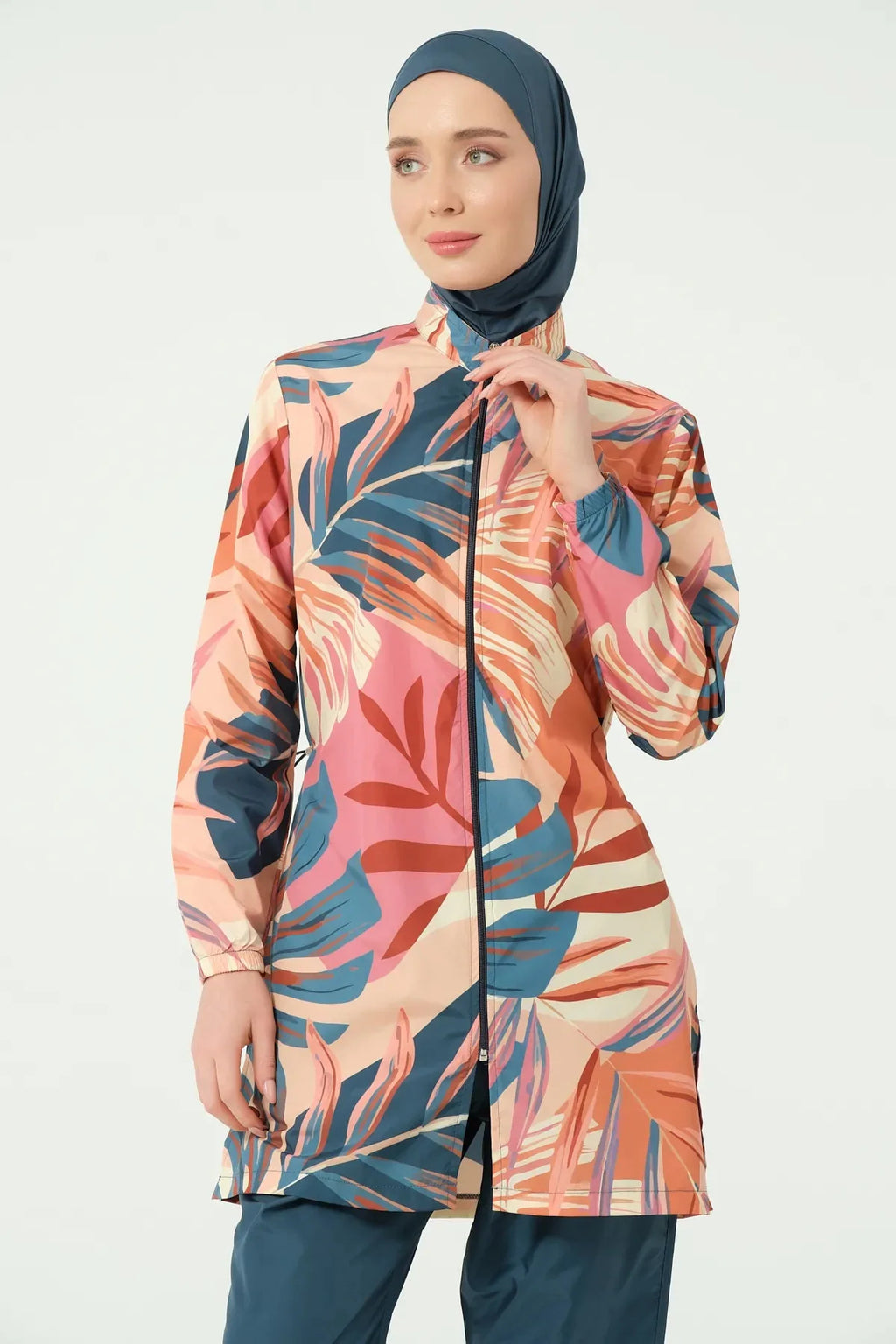 Model in petrol peach tropical burkini set adjusting collar.