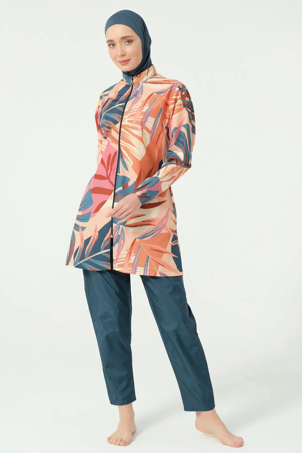 Model in petrol peach tropical burkini set full front view.