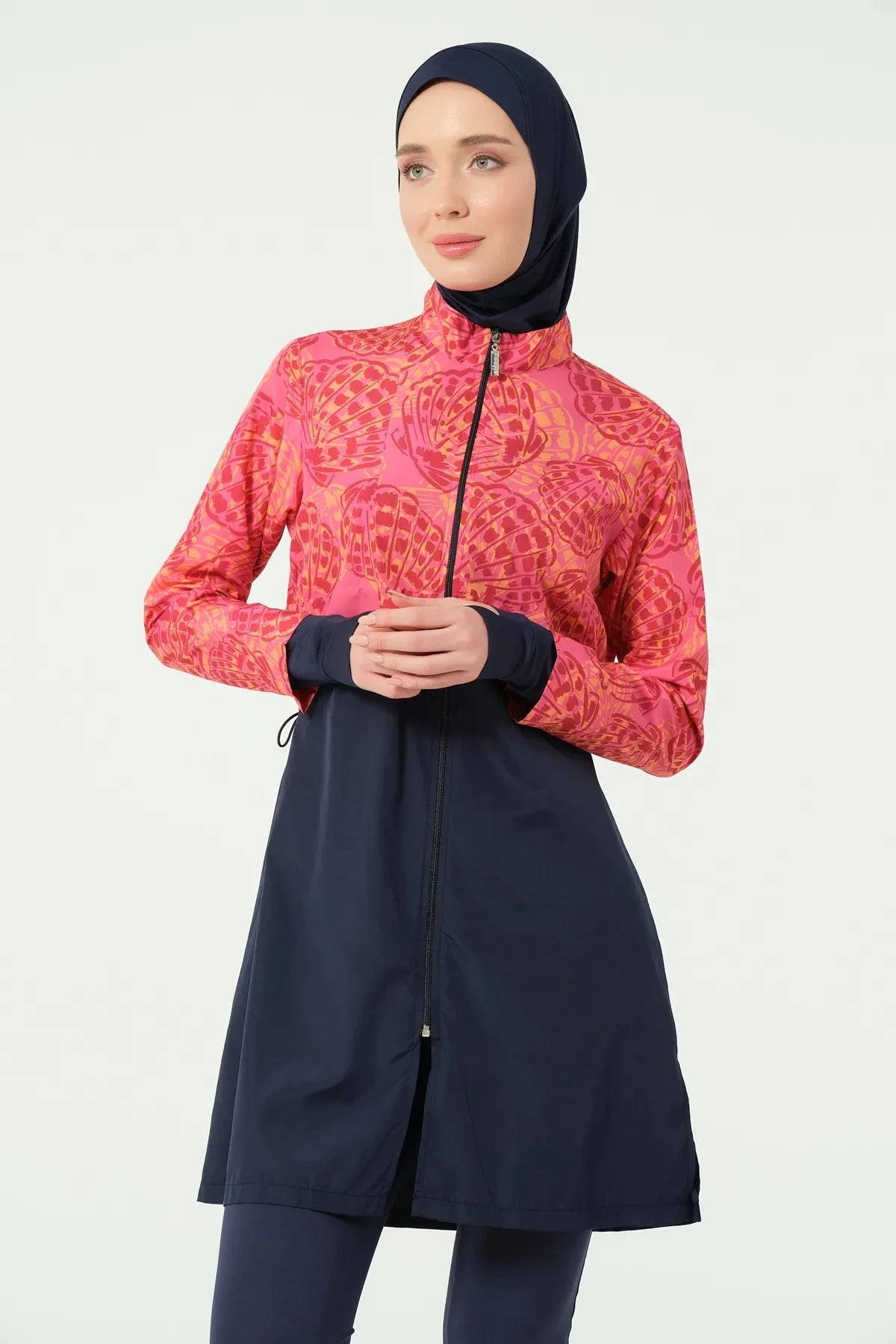 Close-up of woman in navy and coral burkini showing tropical print.