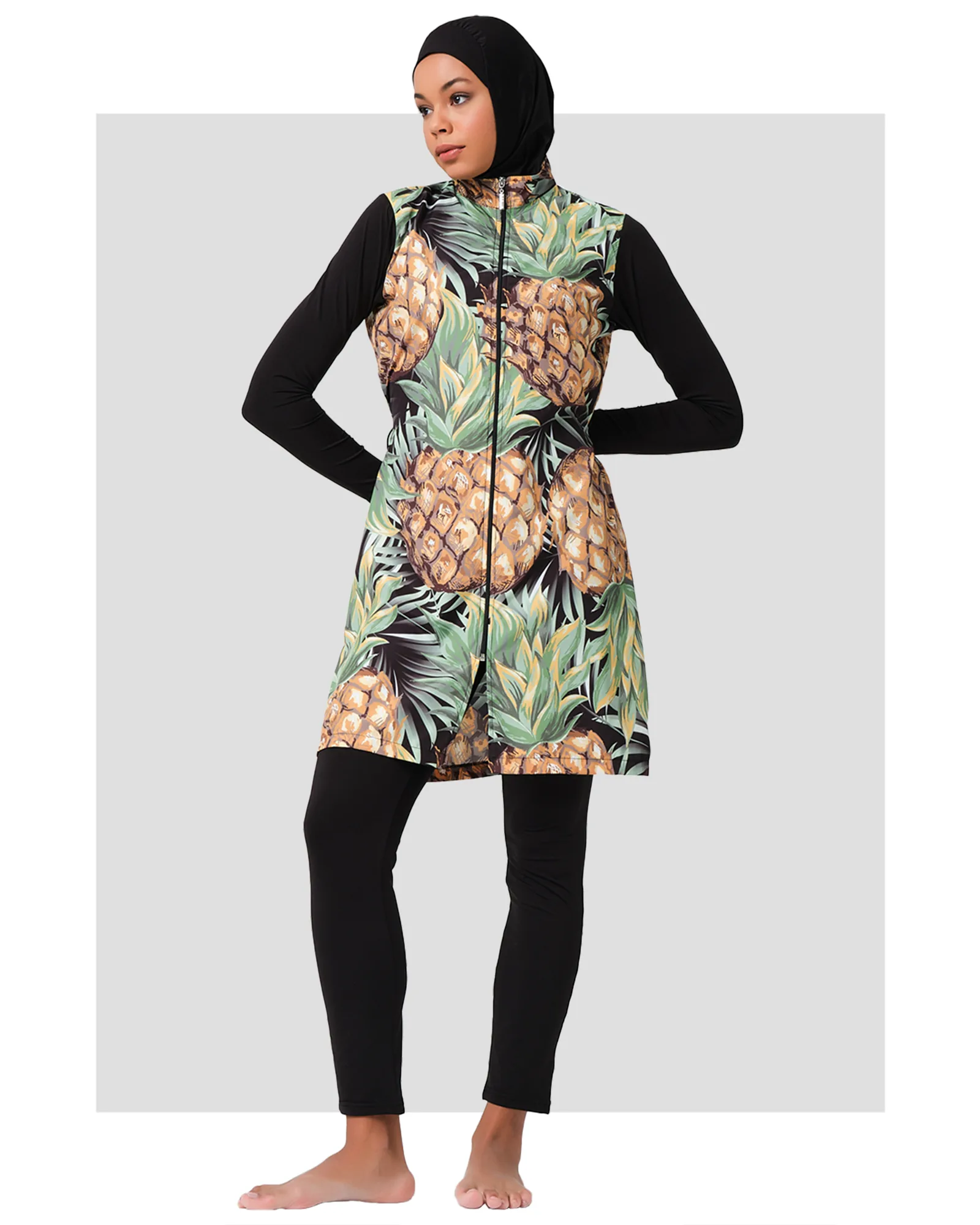 Model wearing tropical pineapple print burkini set front view.