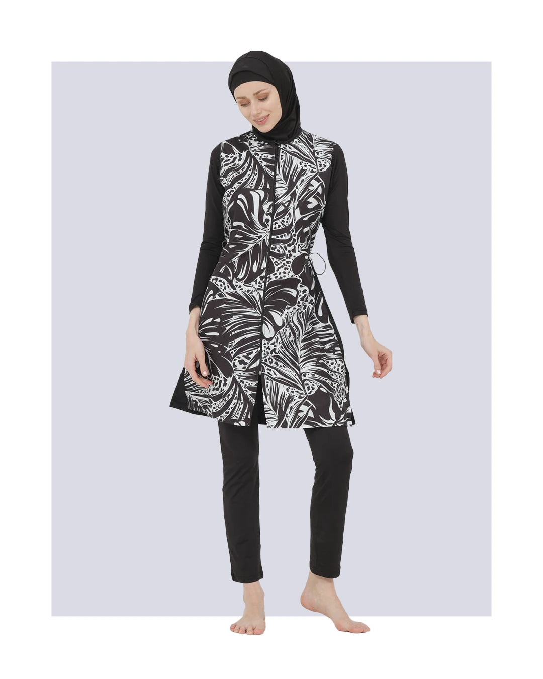 Black and white patterned burkini set front view, model posing.