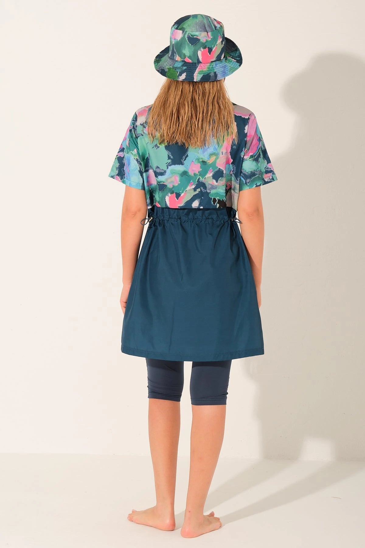Back view of water-repellent burkini set with floral top and sarong.