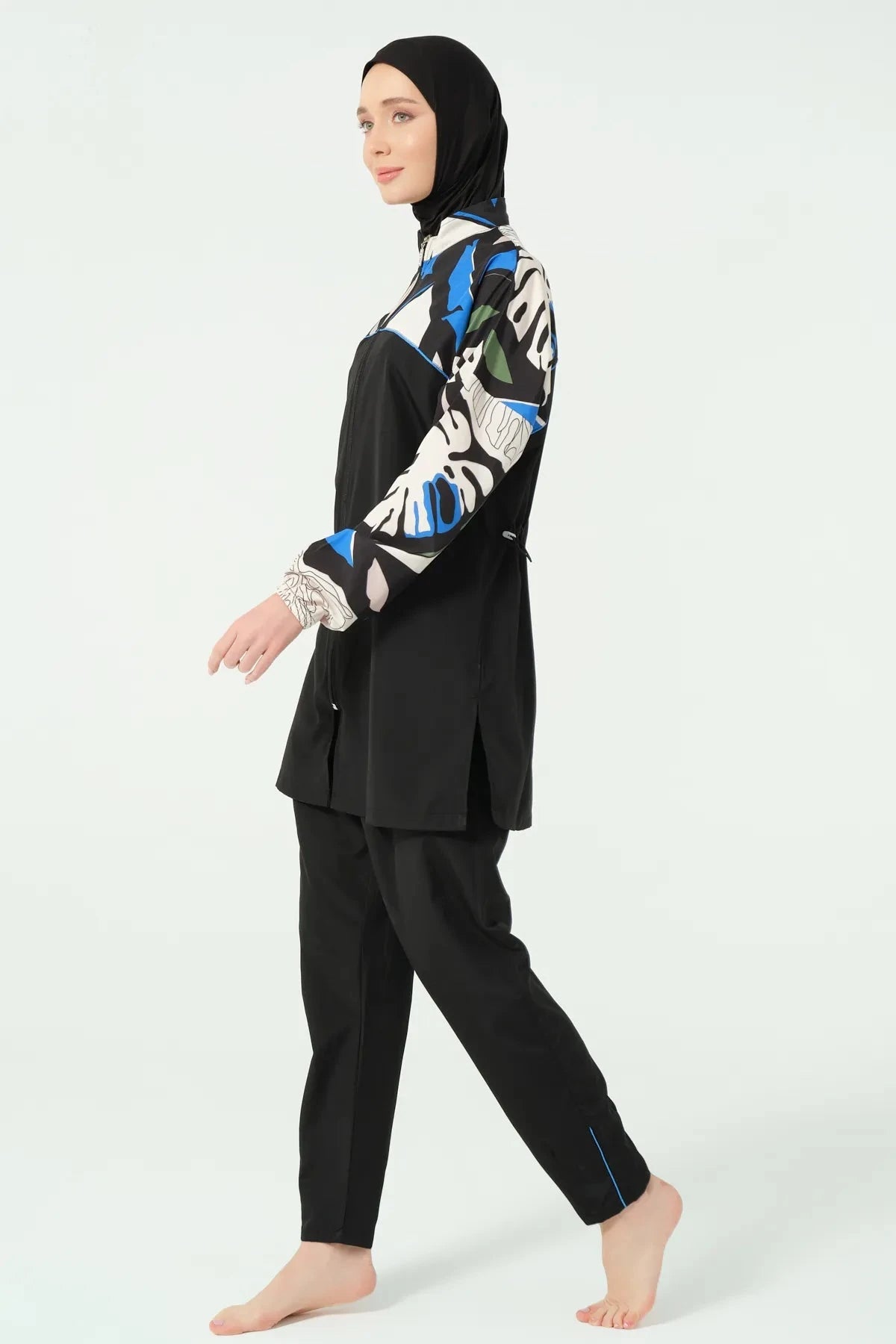 Black burkini set with abstract print, side view walking.