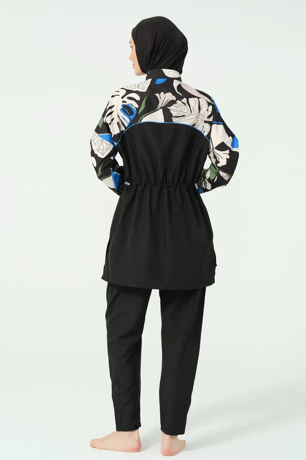 Black modest swimwear with abstract print and drawstring waist, back view.
