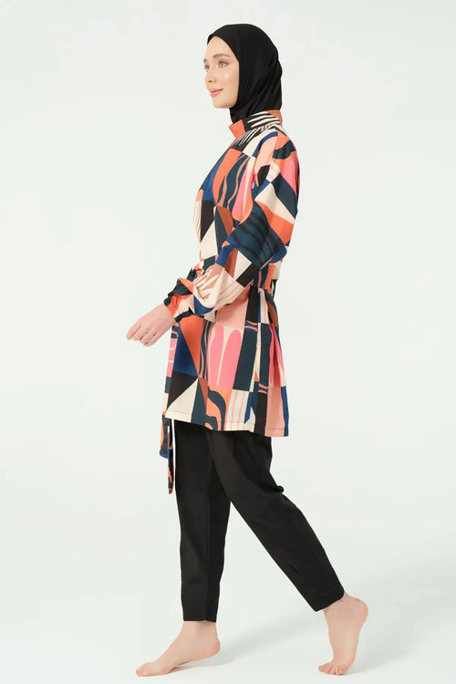 Side view of woman in multi-color geometric print modest swimsuit.