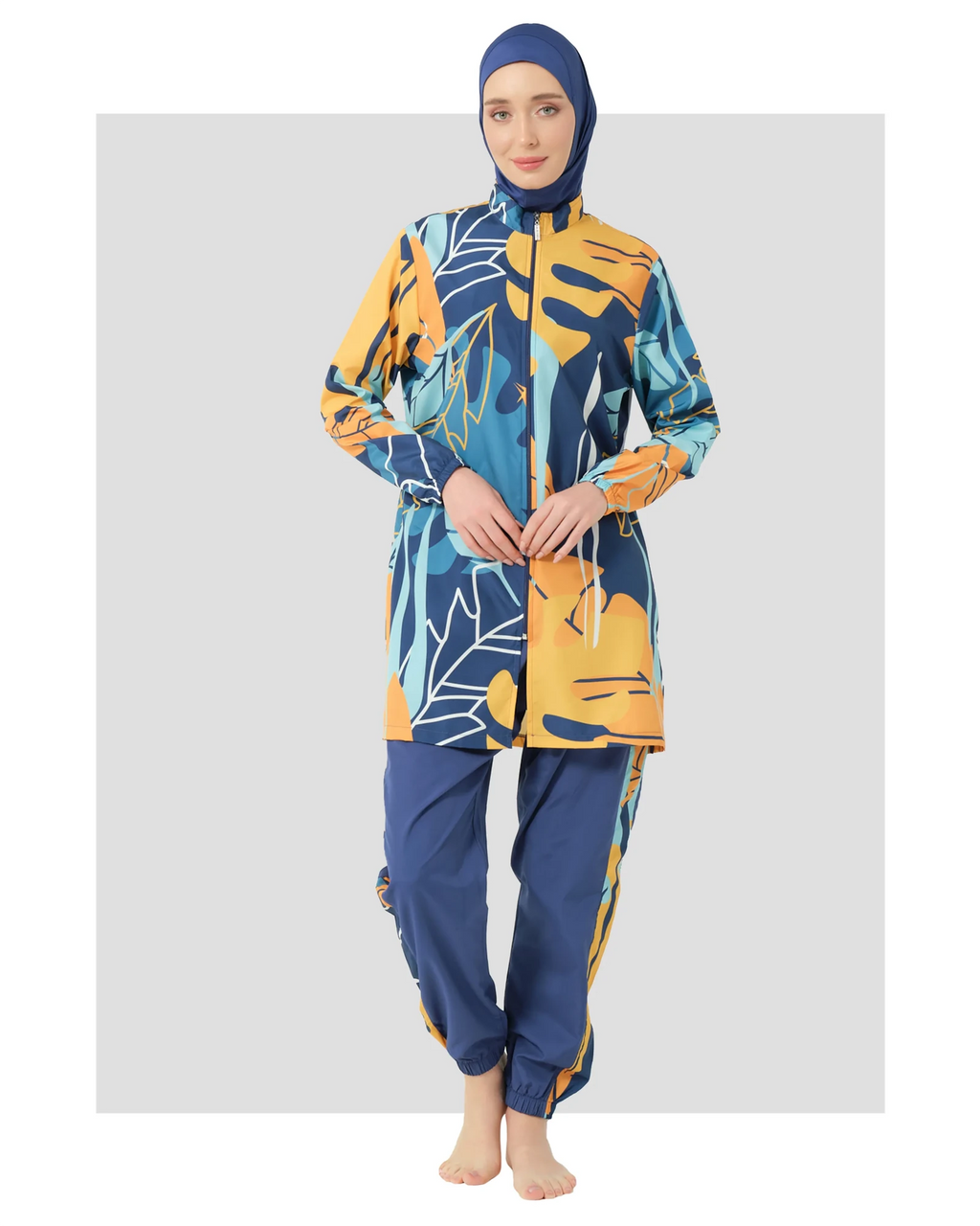 Woman in abstract print modest swimsuit front view on white background.