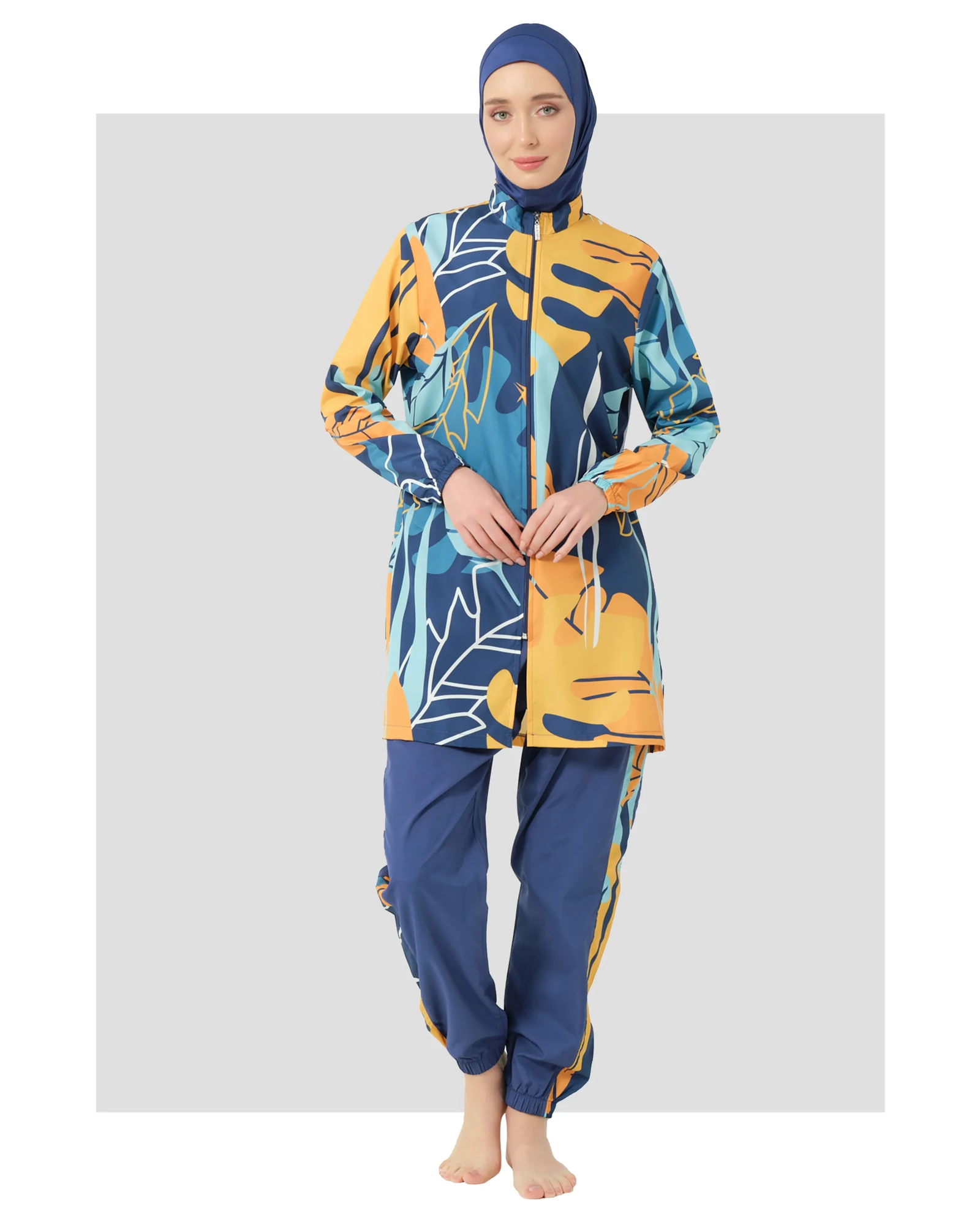 Woman in abstract print modest swimsuit front view on white background.