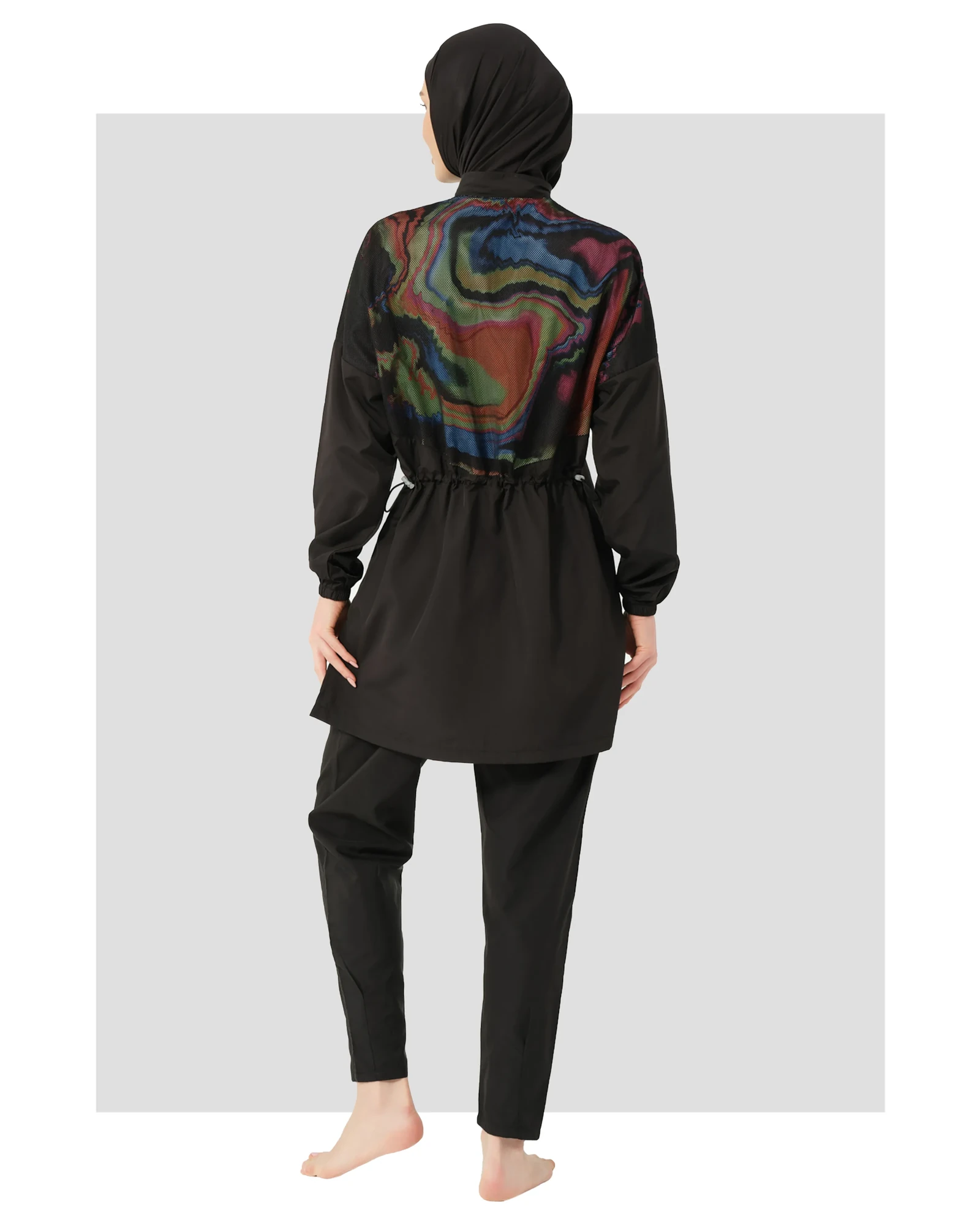 Black modest swimwear back view with colorful watercolor print and hijab.