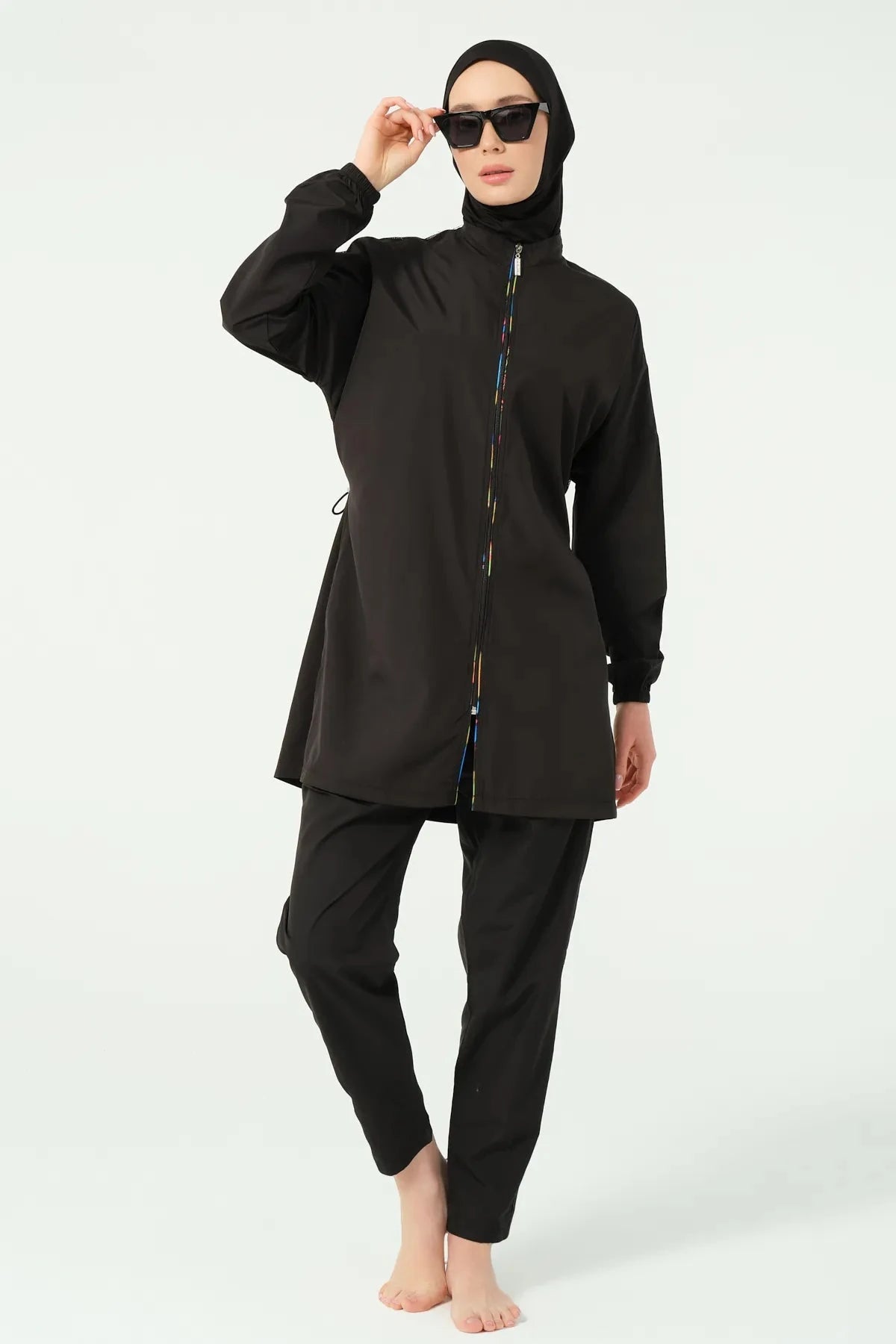 Black modest swimwear front view with hijab and sunglasses.