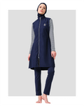 Model standing in navy burkini with striped sleeves and gold anchor.