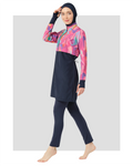 Model wearing abstract print burkini with navy lower and hijab, front view.