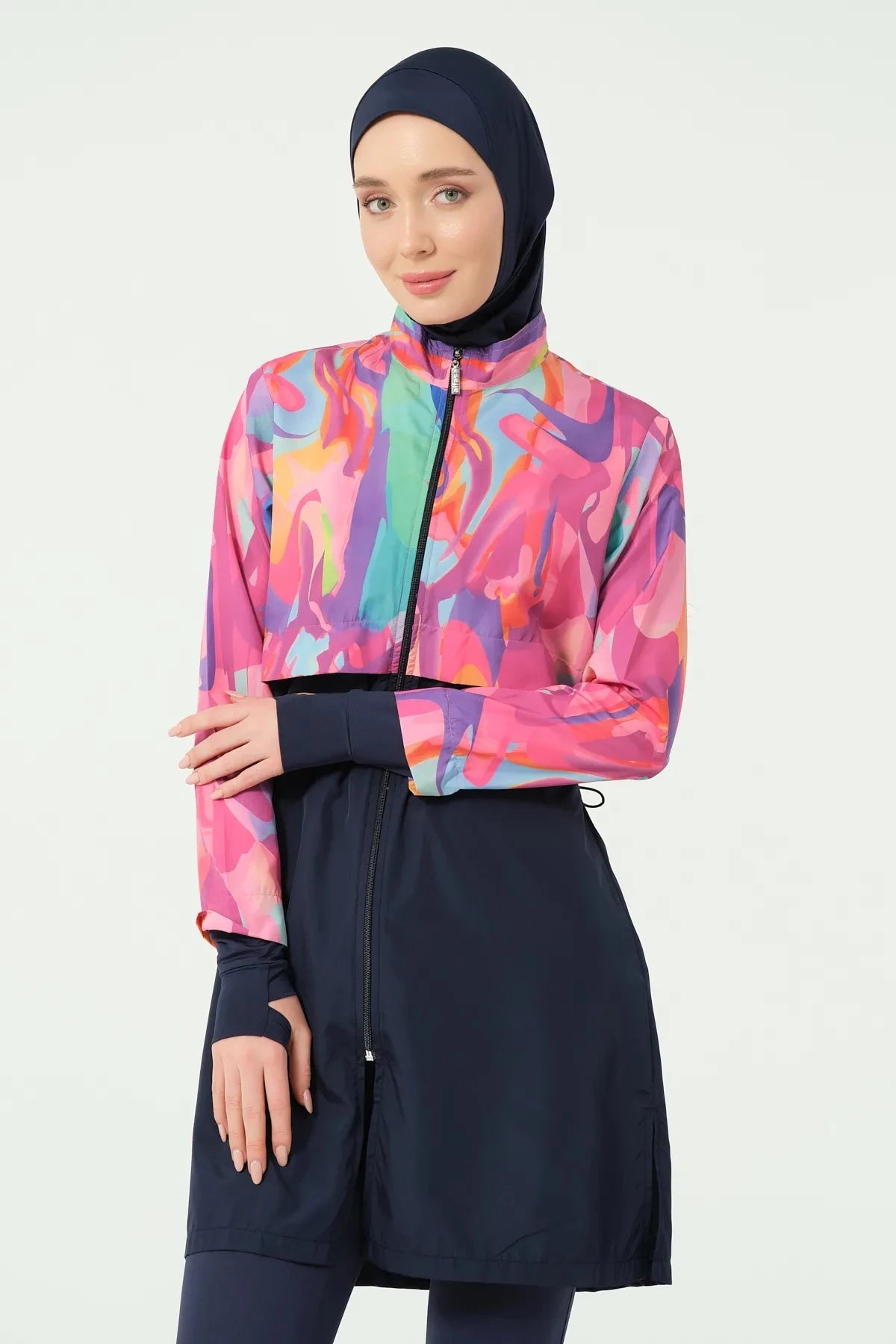 Close-up of model in abstract print burkini, showing thumb hole sleeve.