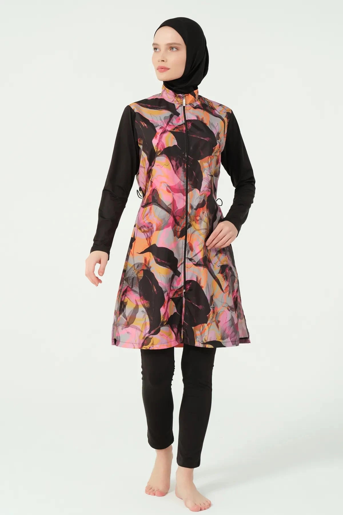 Abstract print burkini top with black sleeves and swim pants, front pose.