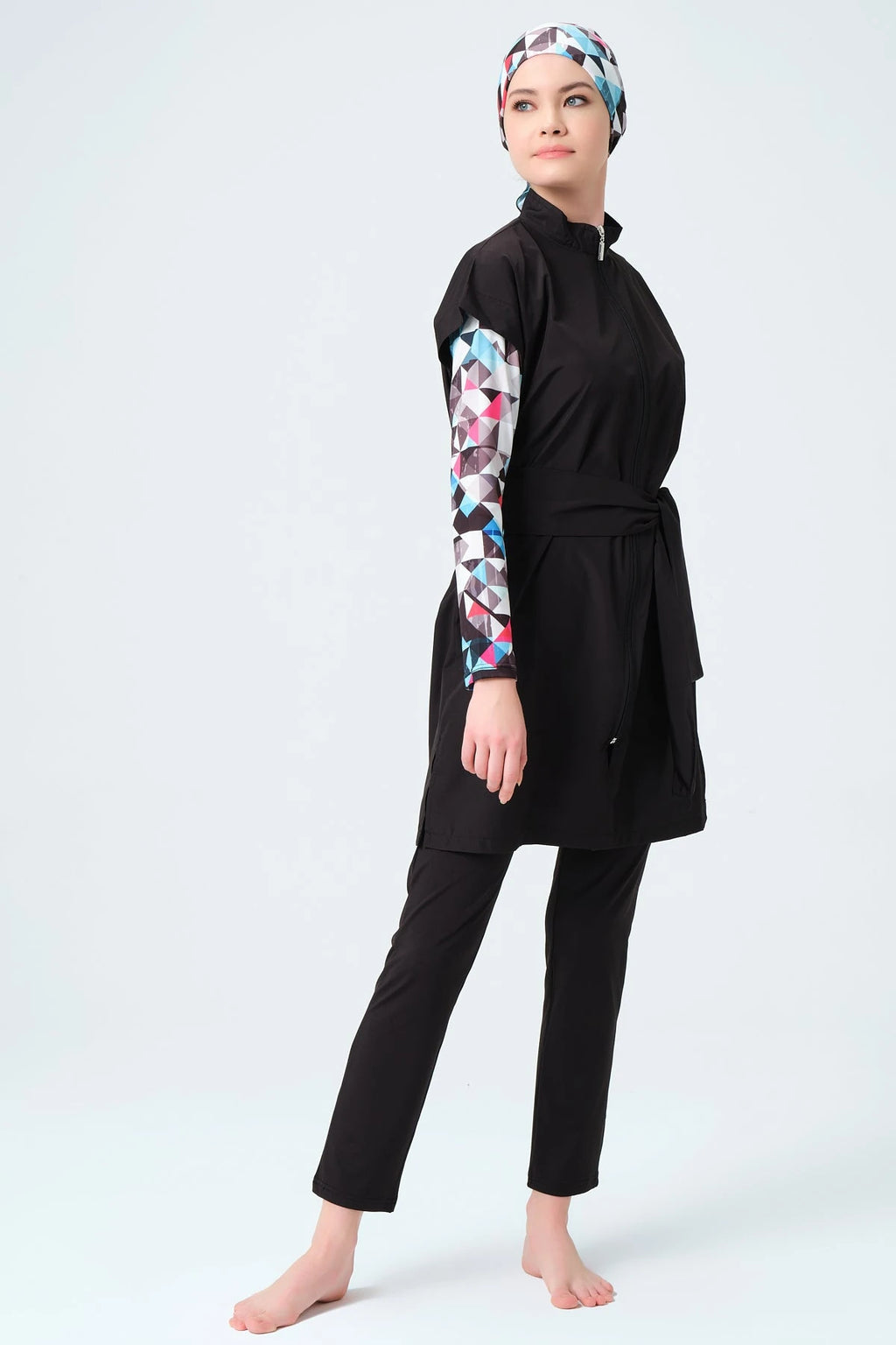 Side view of black layered burkini with geometric print sleeves and hijab.