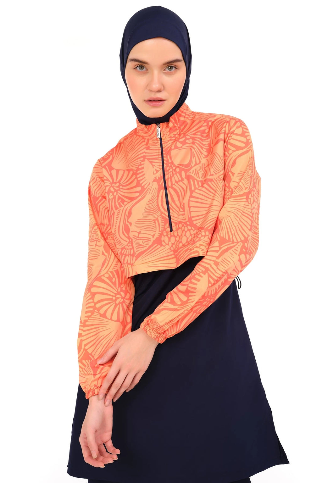 Close-up of sunburst active burkini top with orange print.