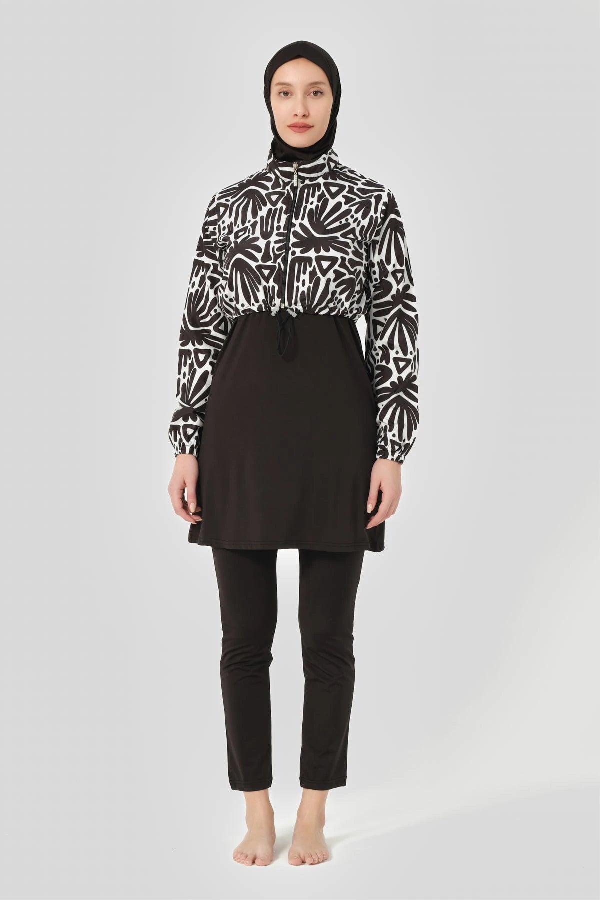 Front view of woman in black and white modest burkini set.