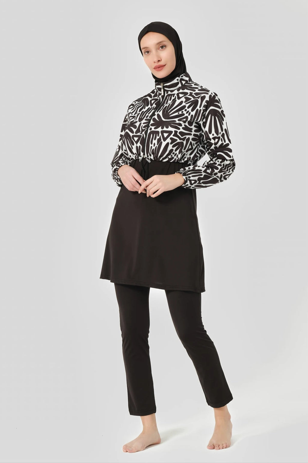 Woman in monochrome modest swimwear set with printed jacket, front pose.