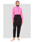 Model in pink patterned cropped jacket, black tunic, pants, and hijab.