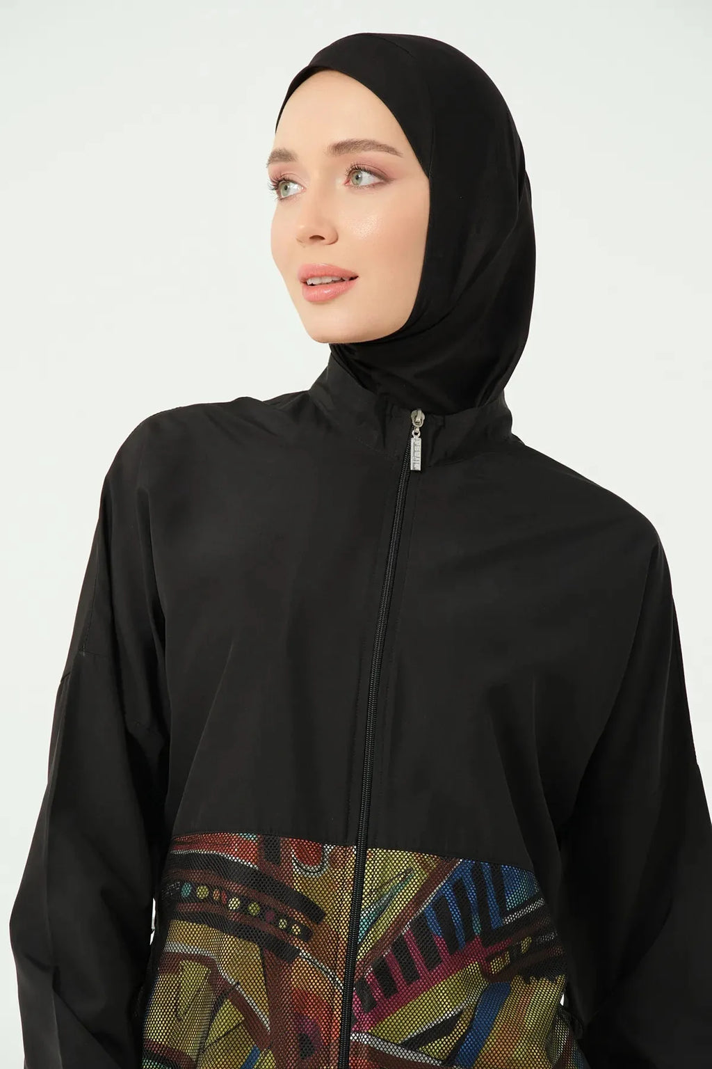 Close-up of black burkini top with front zipper and geometric print.