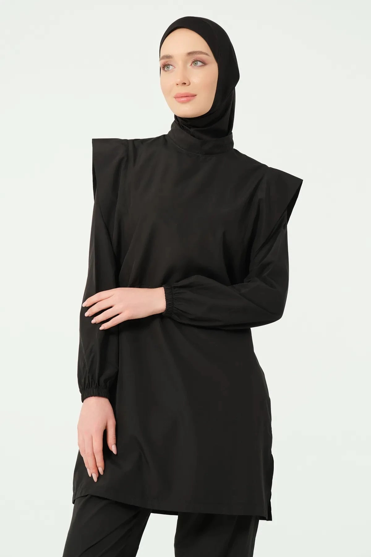 Close-up of black hijab swimwear showing high collar and shoulder detail.