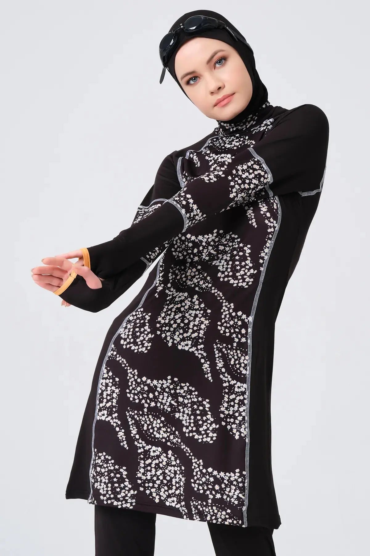 Black floral burkini set on model in a dynamic pose.