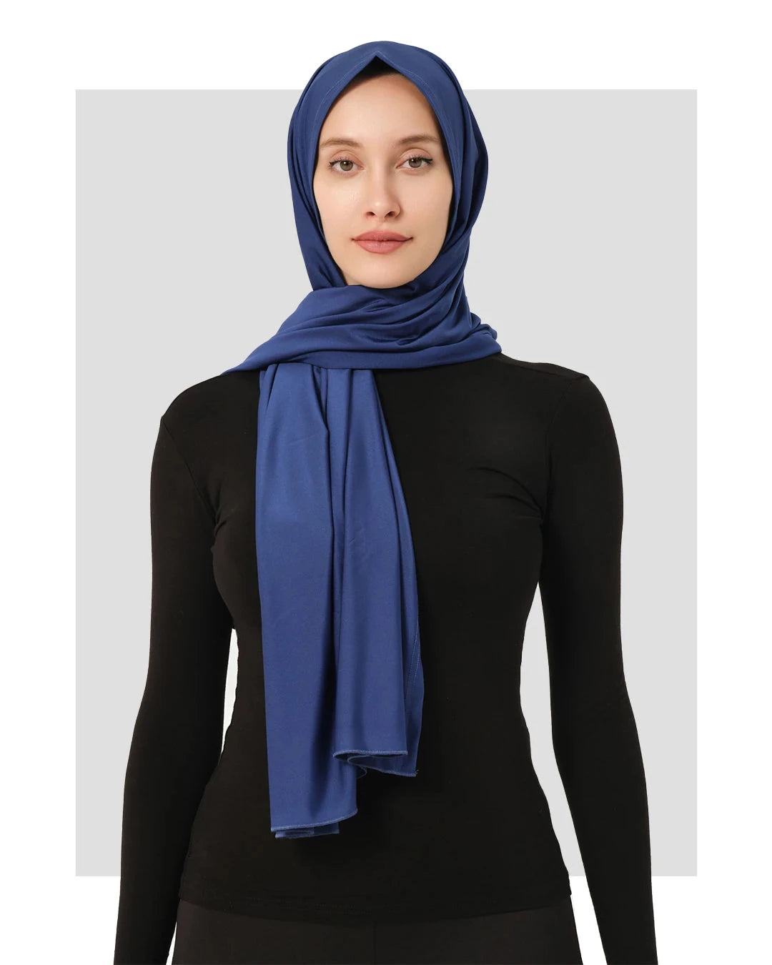 Blue swim hijab worn with black long-sleeved top, front view.