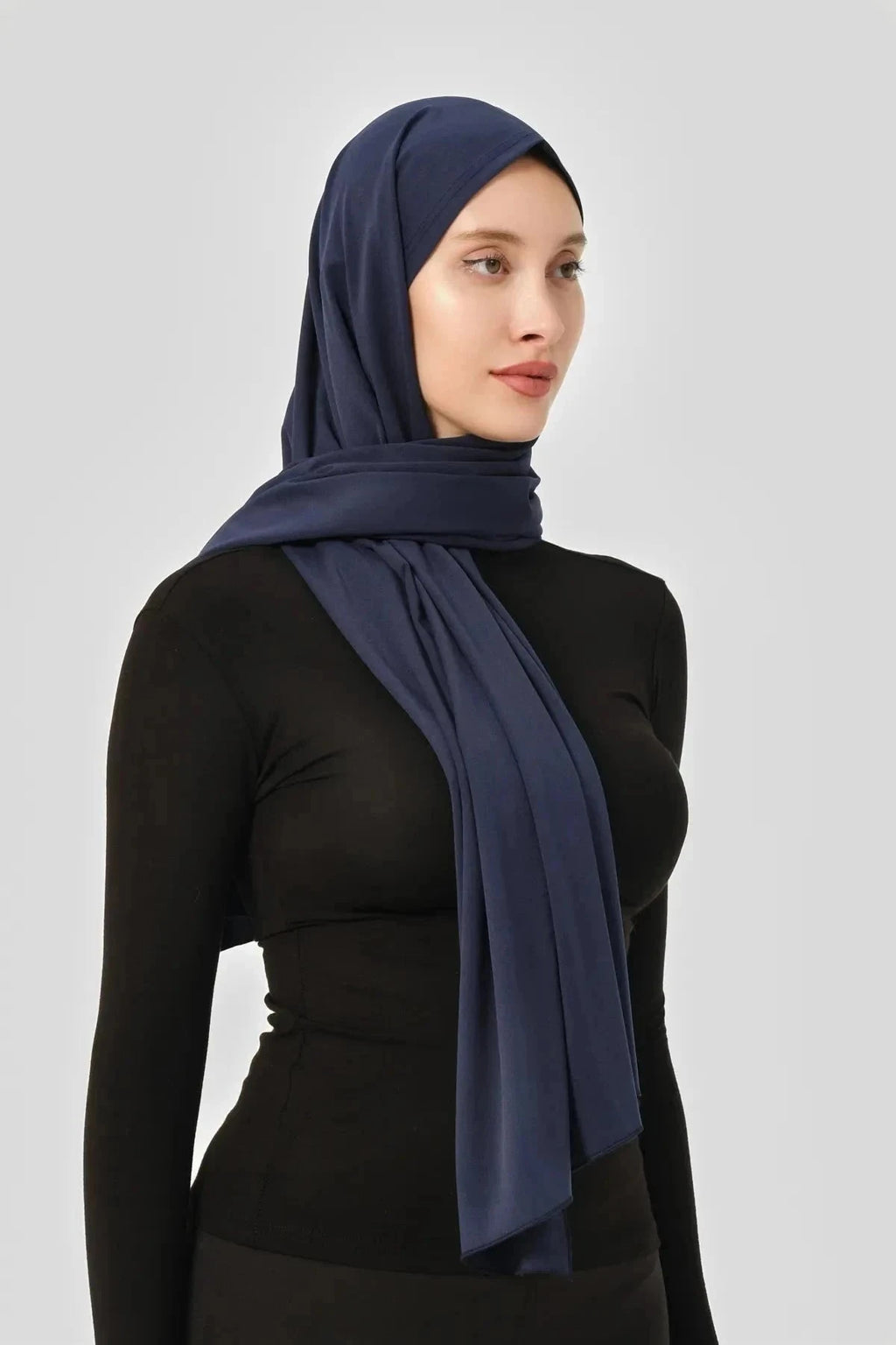 Navy blue swim hijab shown from the side, offering full coverage.