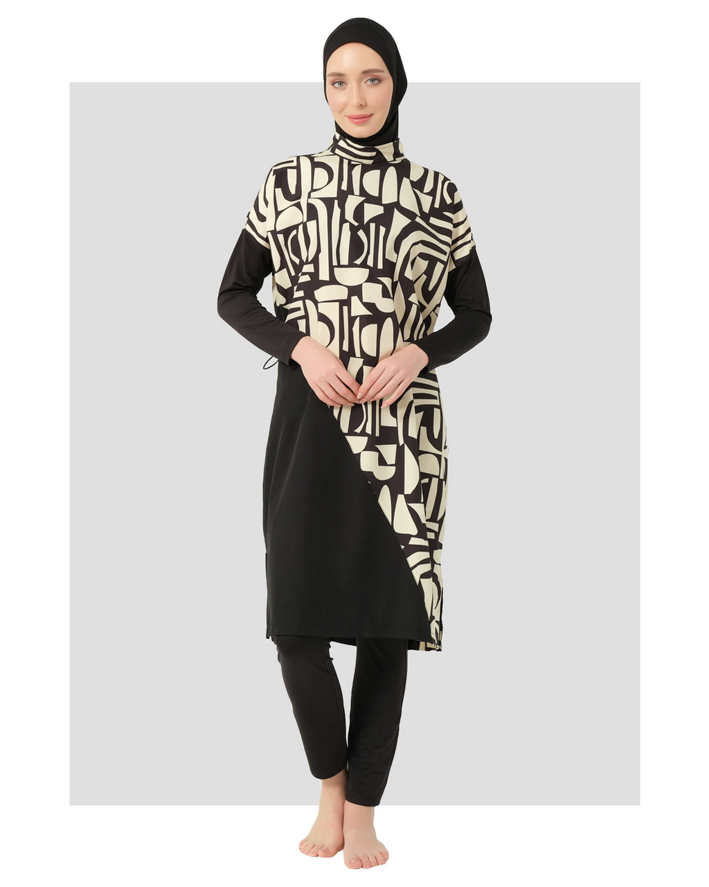 Model in black and beige geometric print burkini front view.