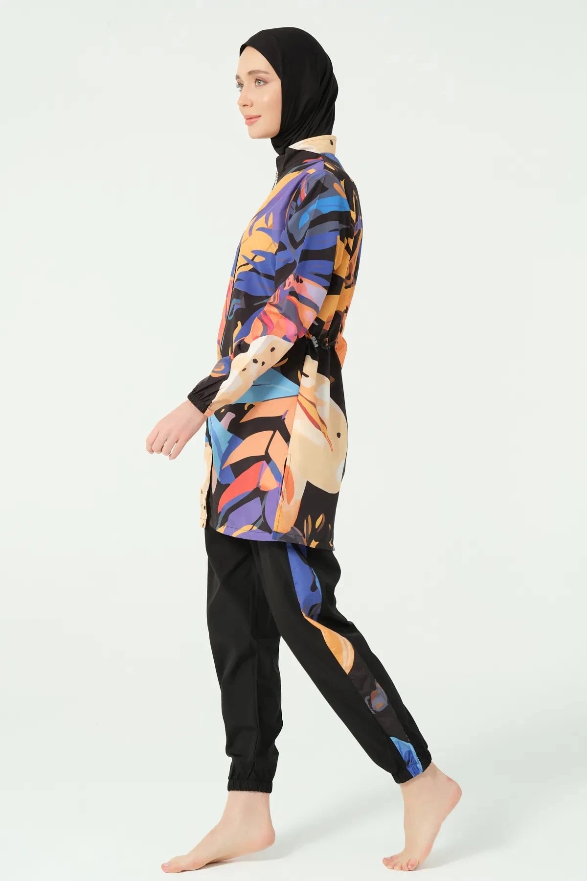 Modest abstract art print burkini side profile walking on light background.