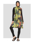 Woman in green tropical print burkini with black leggings and hijab, front view.